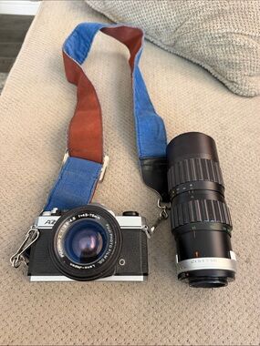 35mm Film Camera with Blue and Brown Strap and Black Telephoto Lens